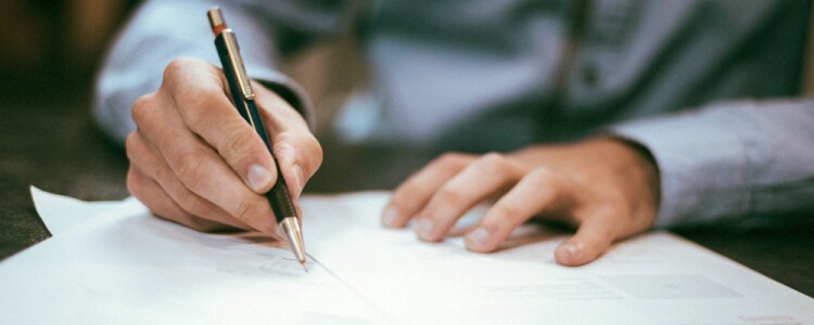 A Man Signing Sponsor Paperwork