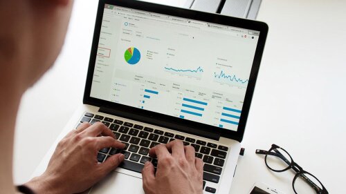 A Person looking investing dashboard via laptop