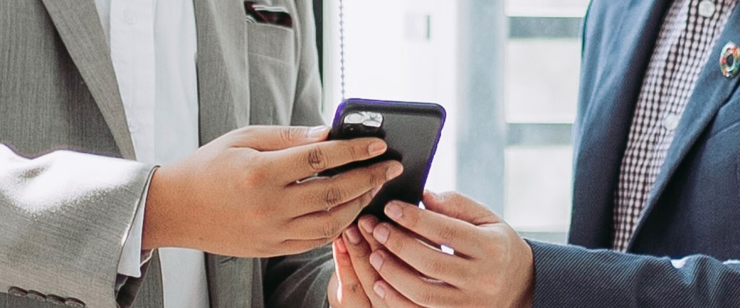 Two men exploring RealtyMogul via phone 